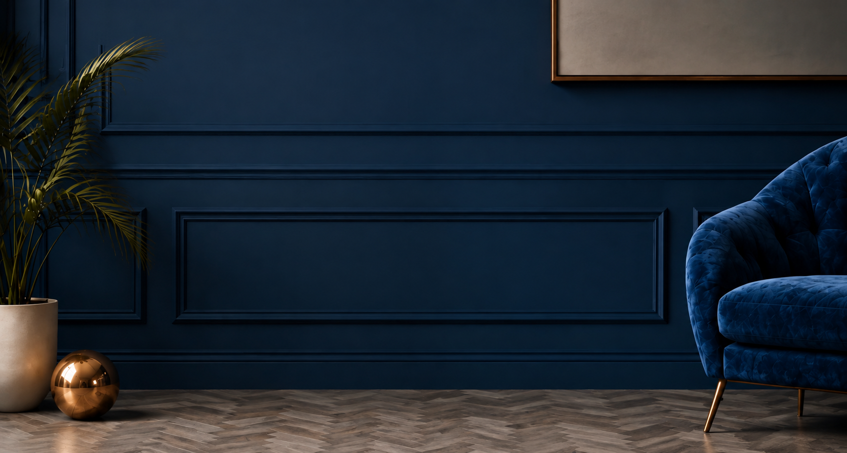 A welcoming room with navy paneling, a leafy palm, and a blue velvet armchair